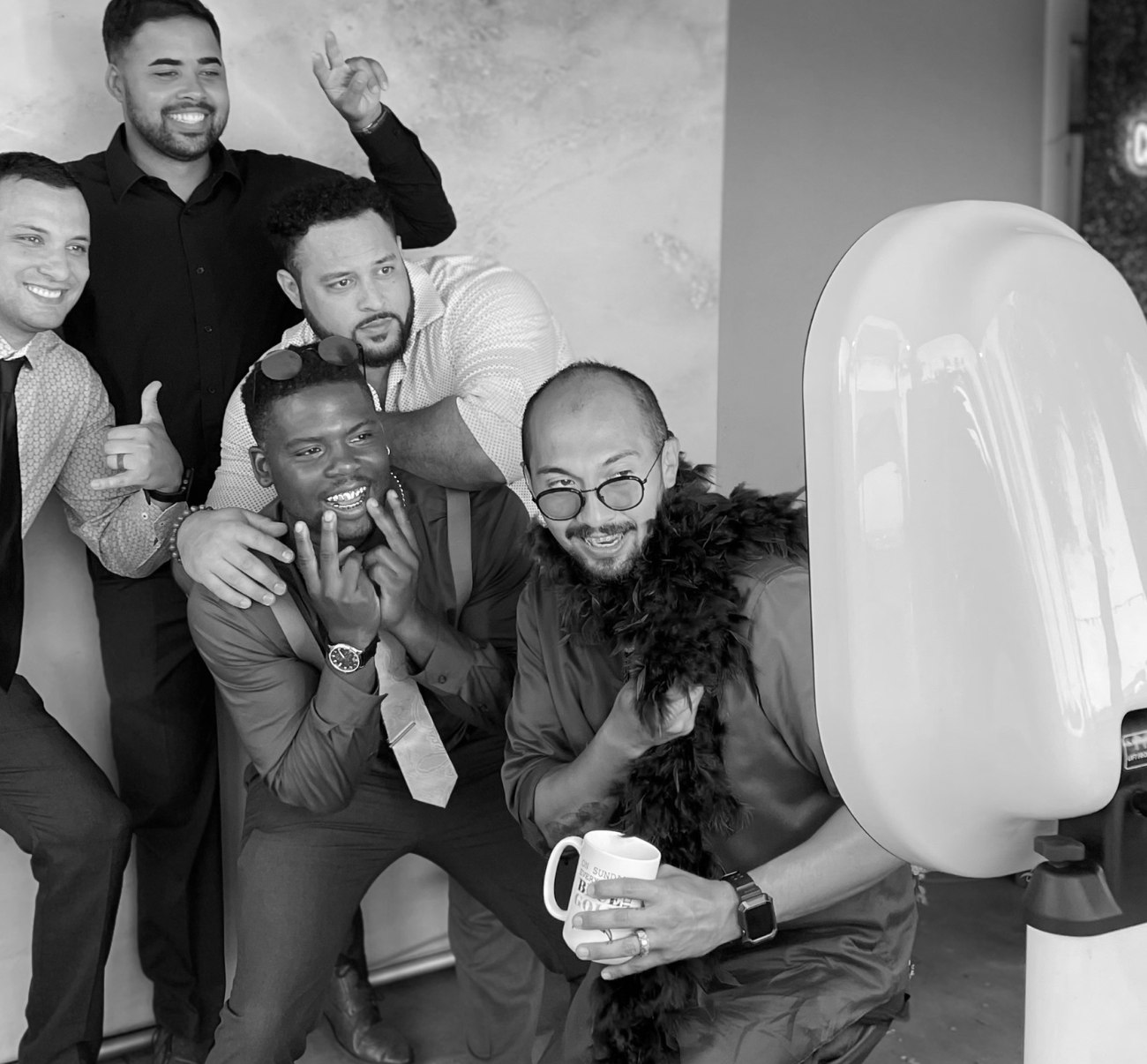 A group of guests laughing together at the booth indoors