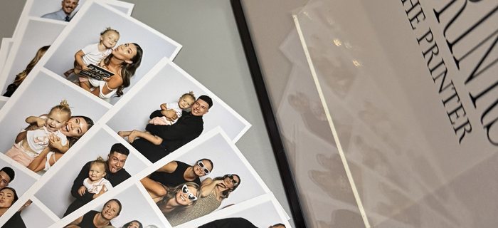 A fan of printed photo strips on a table
