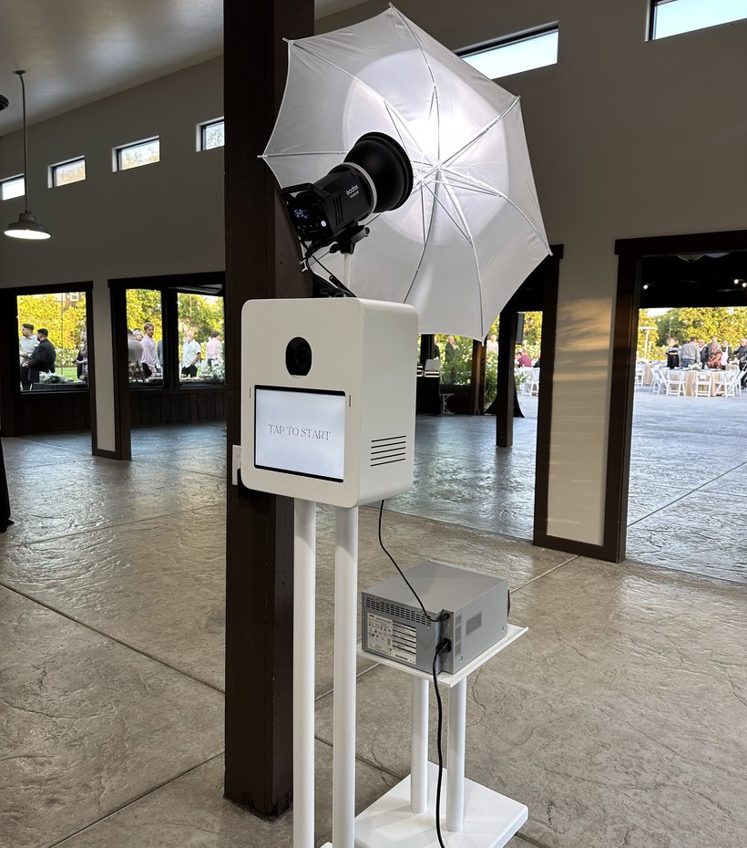 The booth beside a large umbrella softbox inside a venue
