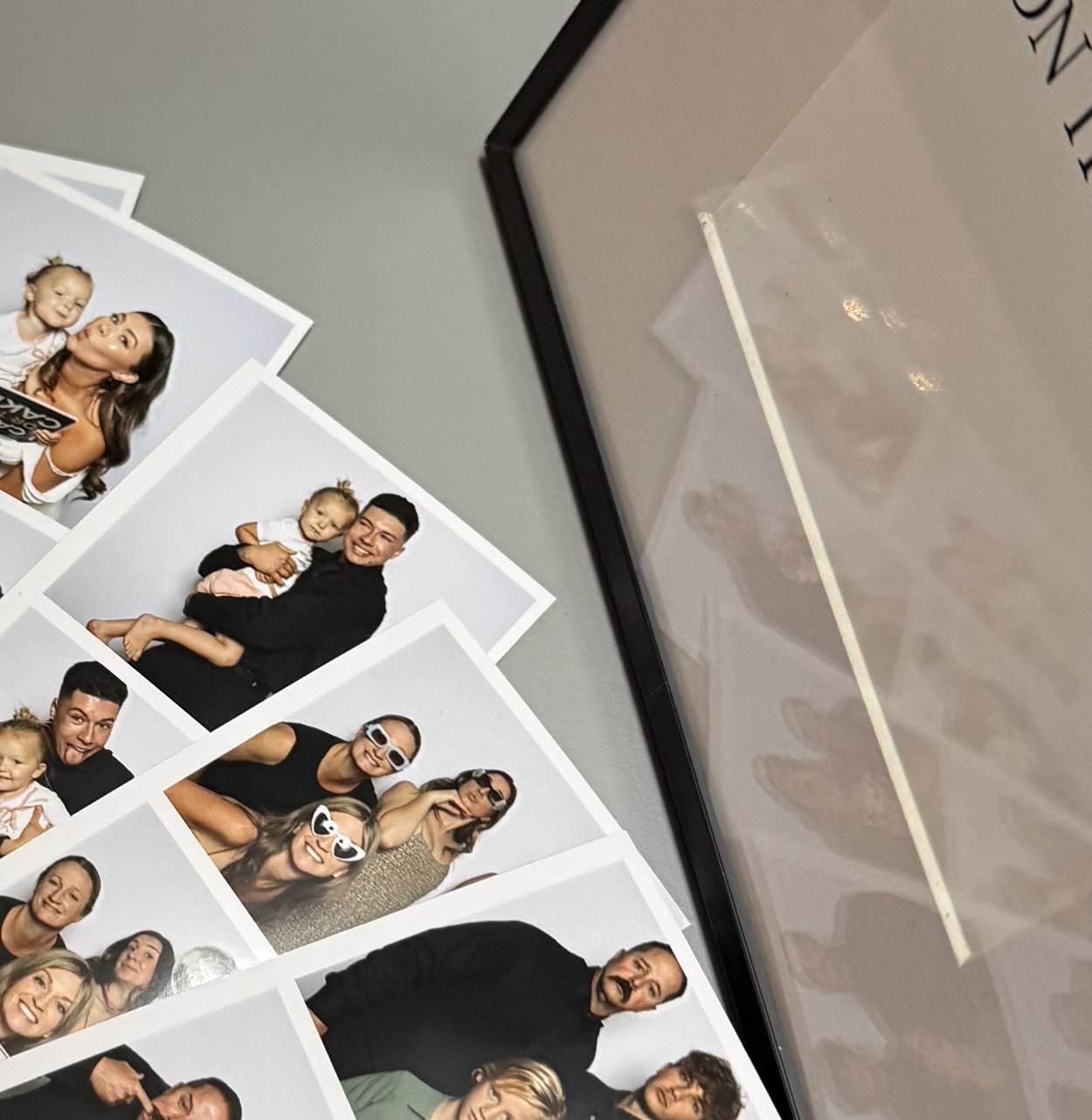 A fan of printed photo strips showing a custom designed layout