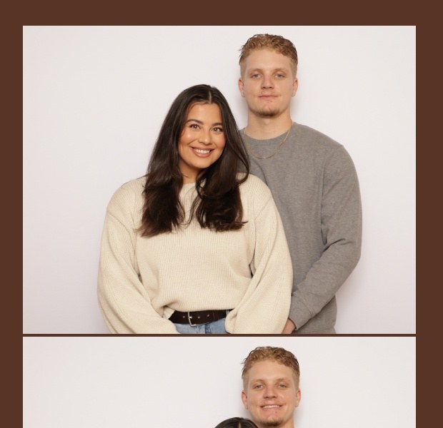 A printed photo strip with wide warm borders around a photo of a couple