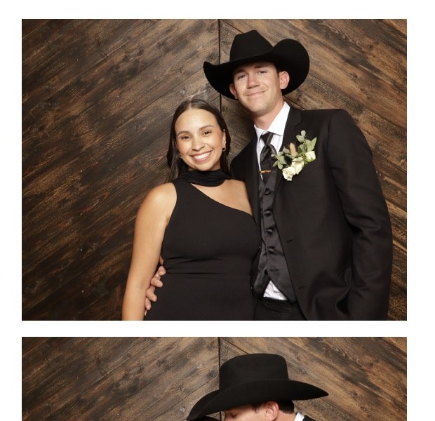 A printed photo strip of a couple posing against a dark wood wall